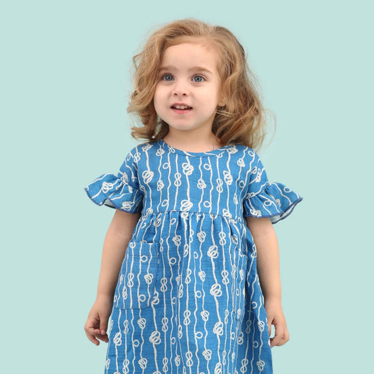 Girl wearing Walkiddy organic Short sleeve dress- sailor's knot