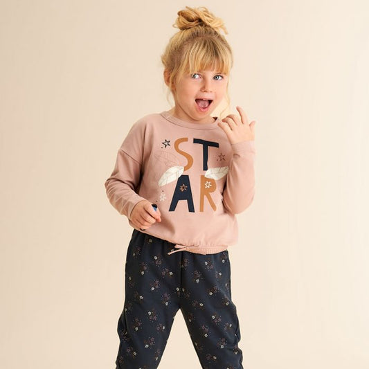 Girl wearing Fred's World organic Long sleeve top- star