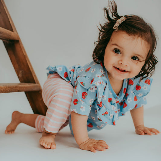 Girl wearing Lilly + Sid Strawberry stripe frill legging set