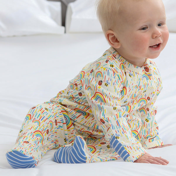 Baby wearing Piccalilly organic Footed pajamas- sun shower