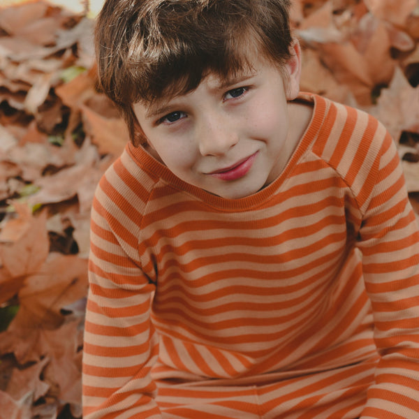 Boy wearing Raglan top- yellow & brown stripes
