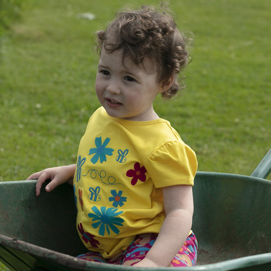 Girl wearing Piccalilly organic Short sleeve top- flowers
