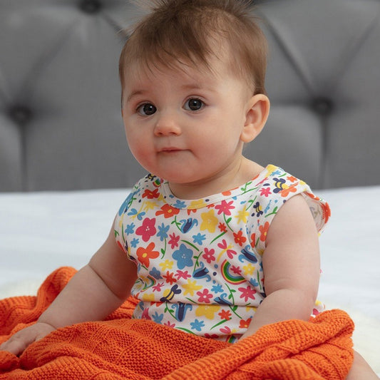 Baby wearing Piccalilly vest bodysuit- rainbow meadow