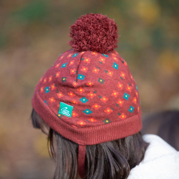 Girl wearing Little Green Radicals organic Knitted hat- hazelnut flowers