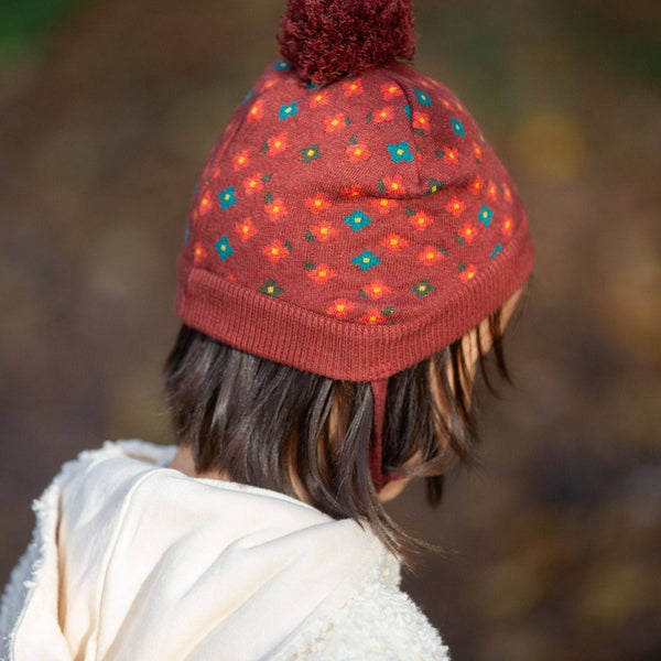 Girl wearing Little Green Radicals organic Knitted hat- hazelnut flowers
