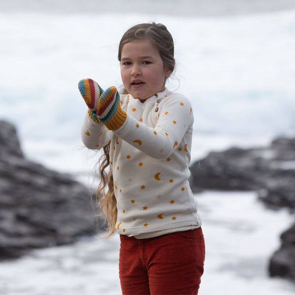 Girl wearing Little Green Radicals Organic Knitted mittens- rainbow stripe