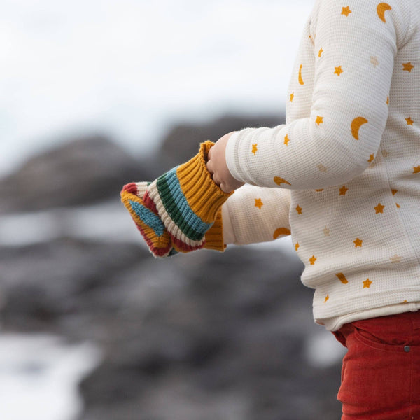 Girl wearing Little Green Radicals Organic Knitted mittens- rainbow stripe