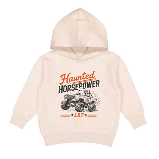 A light beige hooded sweatshirt for toddlers, featuring a graphic print of a monster truck and the text 'Haunted HORSEPOWER' and 'LRT' on the front, set against a plain light gray background.