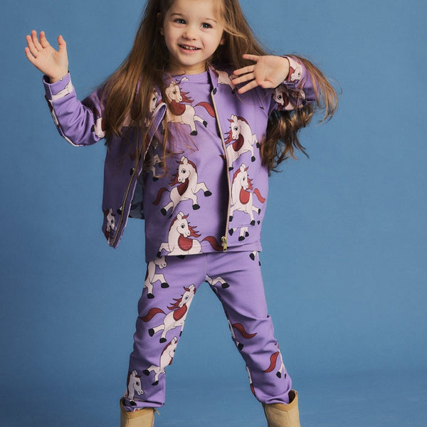 Girl wearing Dear Sophie organic Leggings- horse violet