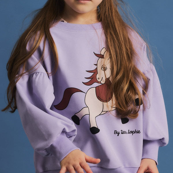 Girl wearing Dear Sophie organic Puff sweatshirt- horse violet