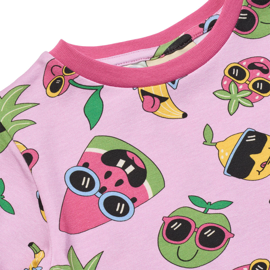 Pink shirt with colorful fruit characters wearing sunglasses on a pink background