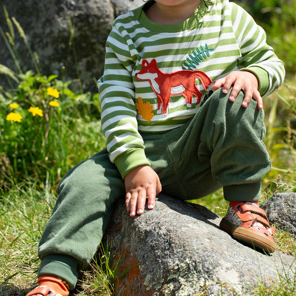 Boy wearing Frugi organic Corduroy pants- khaki green