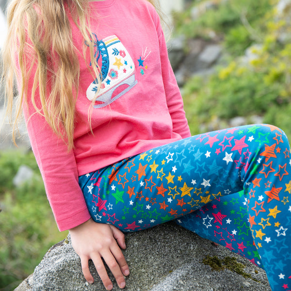 Girl wearing Frugi organic Leggings- rainbow stars
