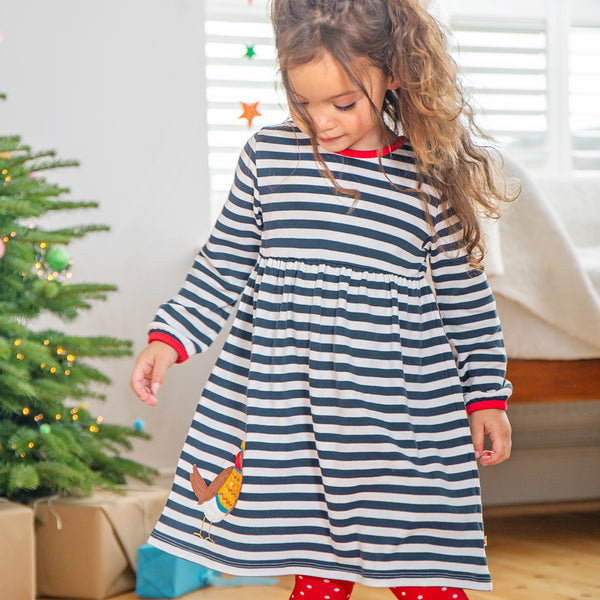 Girl wearing Frugi organic Robin appliqué striped dress
