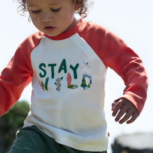 Boy wearing Frugi organic Stay wild raglan top