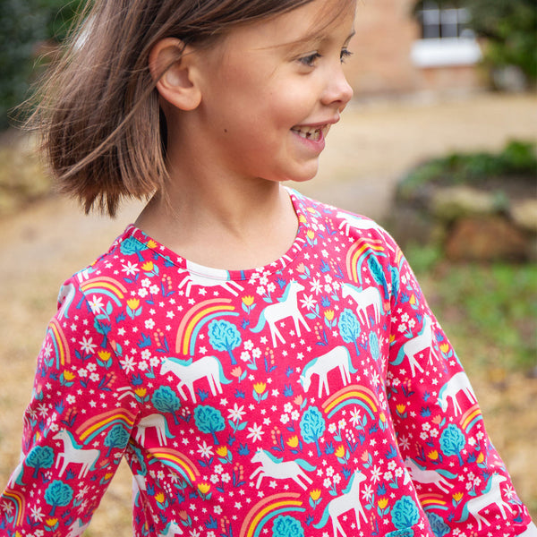 Girl wearing Frugi organic Skater dress- wild horses