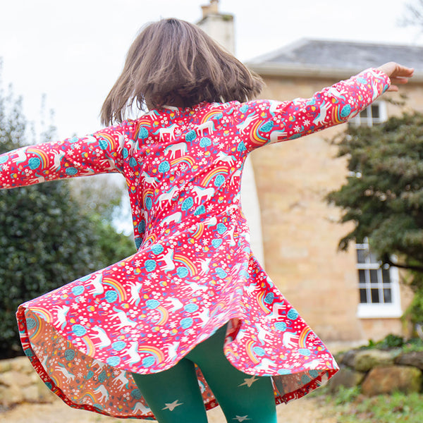 Girl wearing Frugi organic Skater dress- wild horses