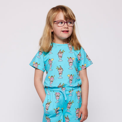 Child wearing a blue t-shirt  with ice cream print on a white background