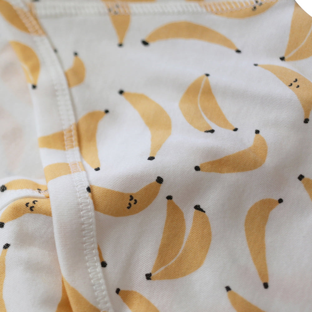 Close-up of fabric with banana pattern on a white background