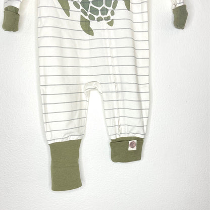 Baby onesie with turtle design and green cuffs on a white background