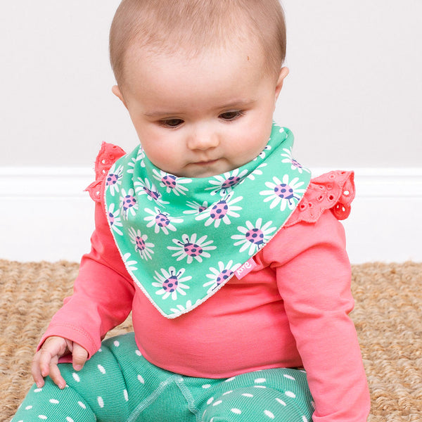 Baby wearing Kite organic Broderie bodysuit