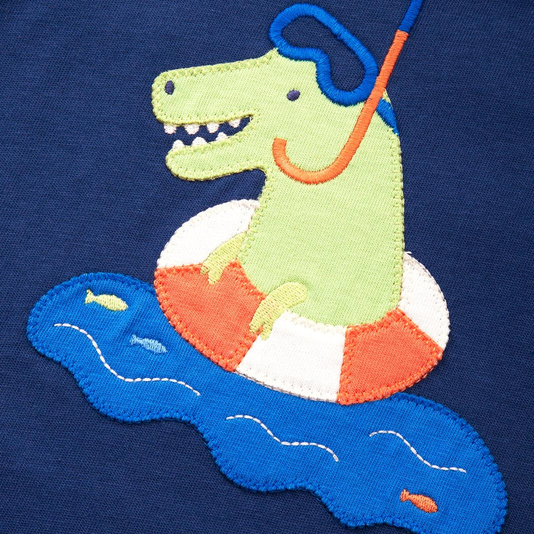 Embroidered design of a dinosaur on an life buoy with snorkel on navy fabric
