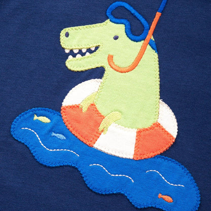 Embroidered design of a dinosaur on an life buoy with snorkel on navy fabric