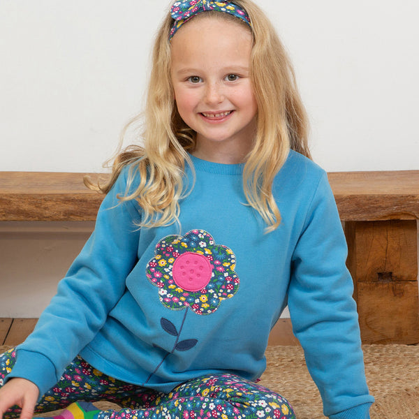 Girl wearing Kite organic Flower appliqué sweatshirt