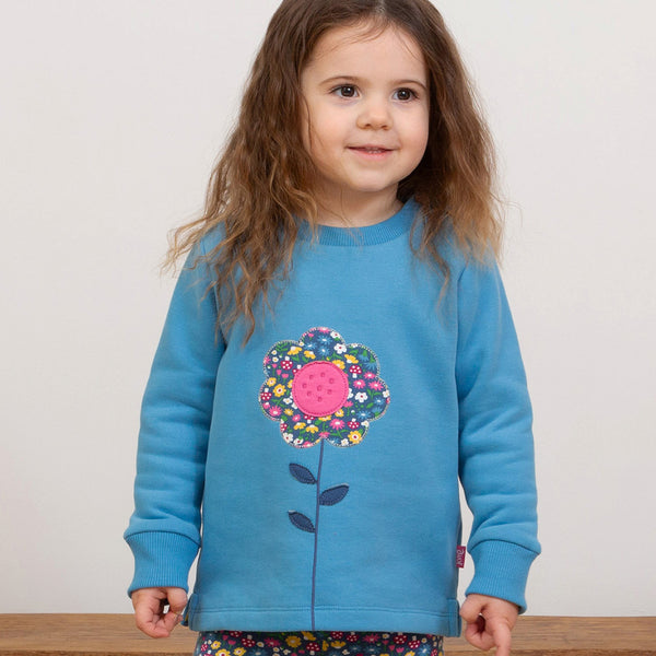 Girl wearing Kite organic Flower appliqué sweatshirt