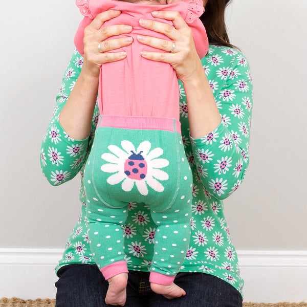 Baby wearing Kite organic Lazy daisy knit leggings