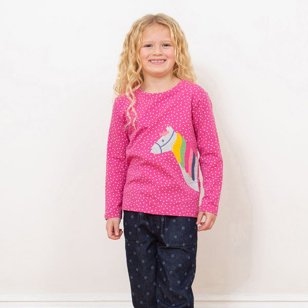 Girl wearing Kite organic Rainbow pony appliqué t-shirt