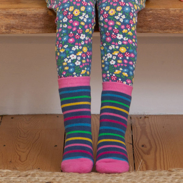 Girl wearing Kite organic Tiger grippy socks- blush pink