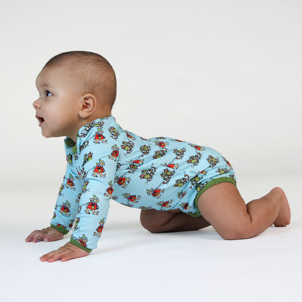 Baby wearing Smafolk organic Long sleeved bodysuit- sledding rabbits, stratosphere blue