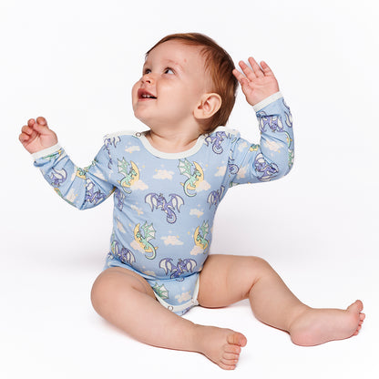 Baby wearing Smafolk organic Long sleeved bodysuit- sleeping dragons