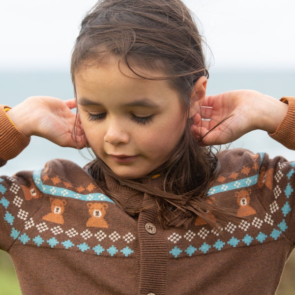 Girl wearing Little Green Radicals organic Fair Isle bear knit cardigan
