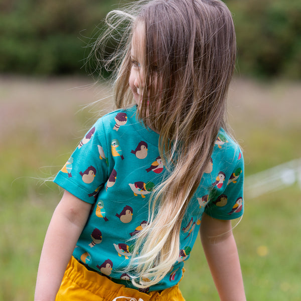 Girl wearing Little Green Radicals organic Garden birds short sleeve t-shirt