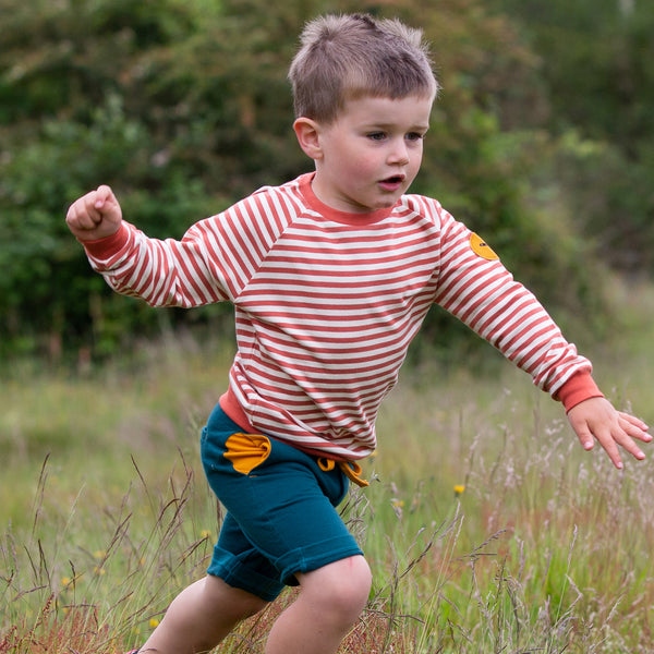 Boy wearing Little Green Radicals organic Green marl jogger shorts