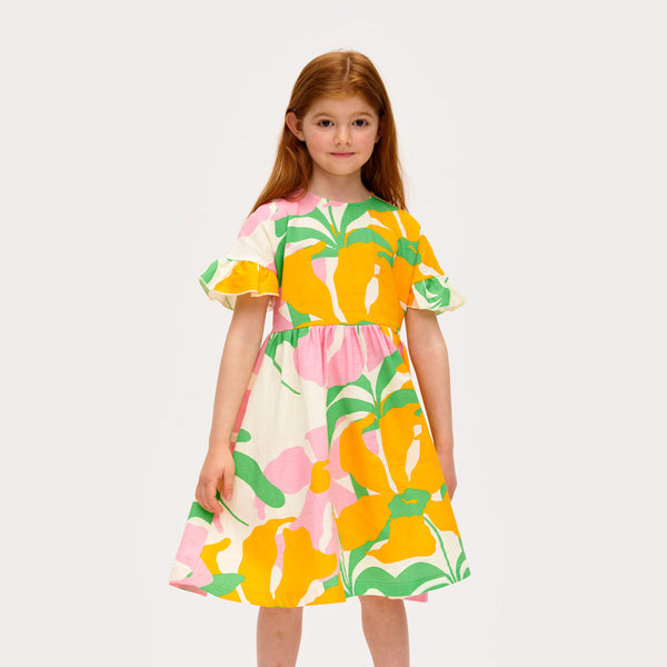 Girl wearing Mainio organic Muslin dress- lively floral