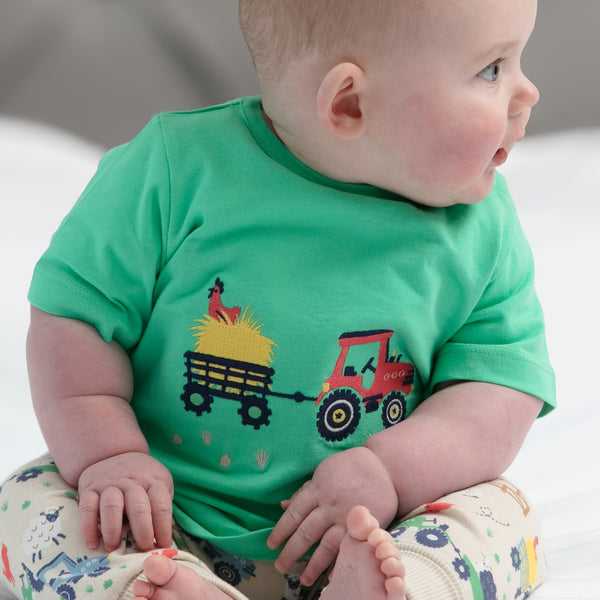 Baby wearing Piccalilly organic Top & pants playset- on the farm
