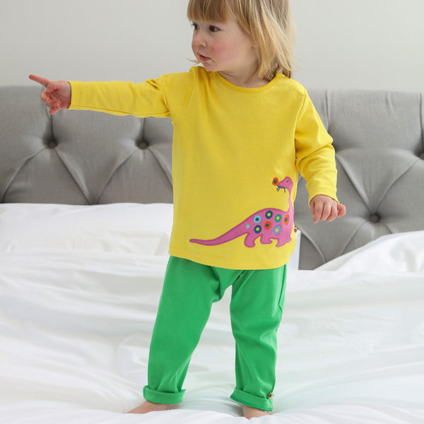 Girl wearing Piccalilly organic Long sleeve top- dinosaur appliqué