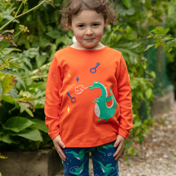 Girl wearing Piccalilly organic Long sleeve top- dragon appliqué