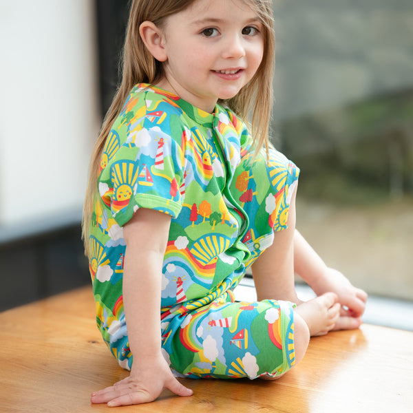Girl wearing Piccalilly organic Shortie romper- island life