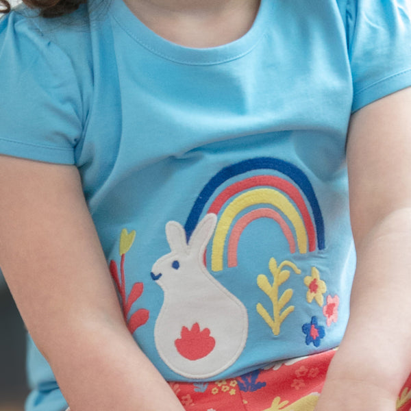 Girl wearing Piccalilly organic Short sleeve top- rainbow bunny appliqué