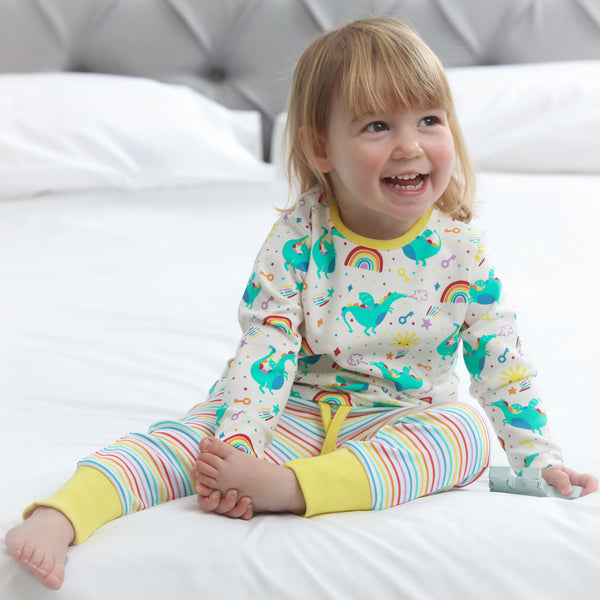 Girl wearing Piccalilly organic Pajamas- rainbow dragon