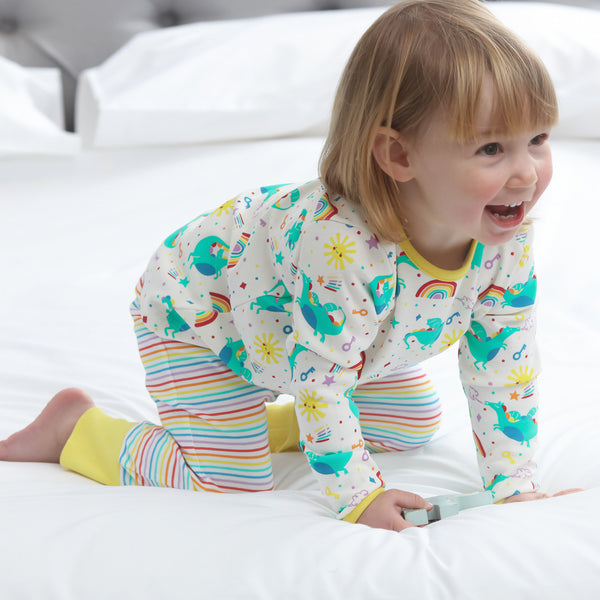 Girl wearing Piccalilly organic Pajamas- rainbow dragon