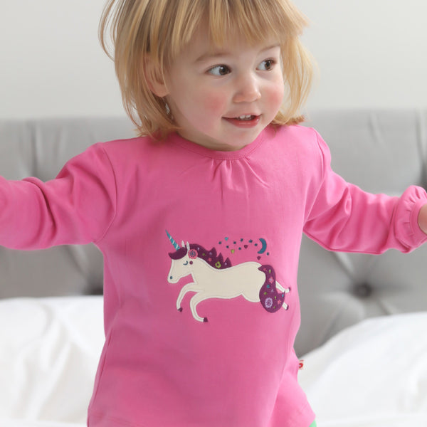 Girl wearing Piccalilly organic Tunic- unicorn appliqué