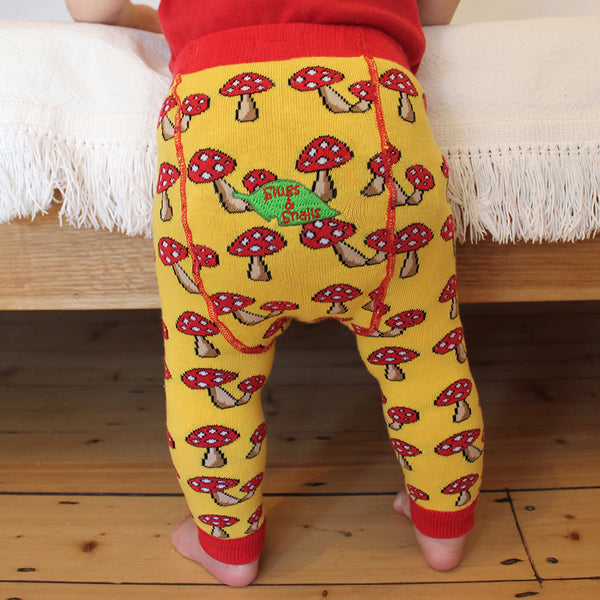 Baby wearing Slugs & Snails organic Mushroom patterned tights