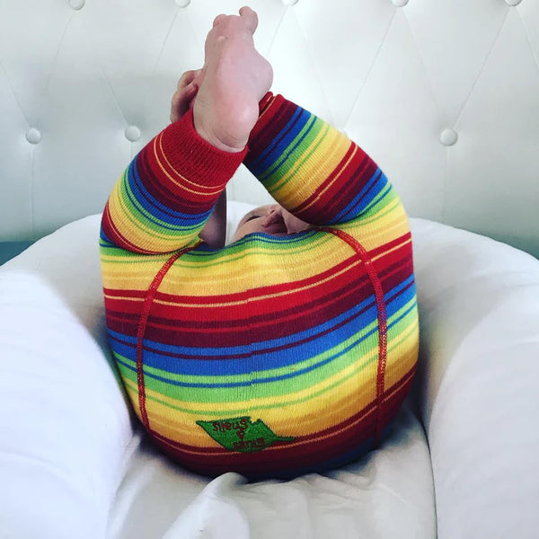 Baby wearing Slugs & Snails organic Rainbow footless tights