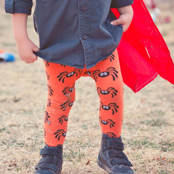 Baby wearing Slugs & Snails organic Spider patterned tights