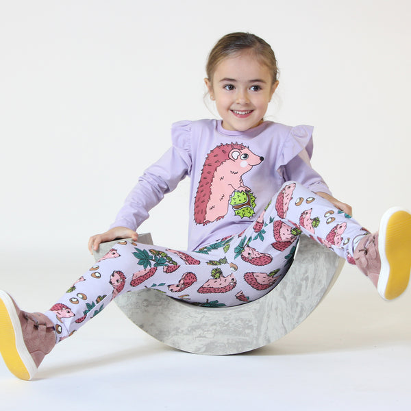 Girl wearing Smafolk organic Leggings- hedgehogs, orchid petal